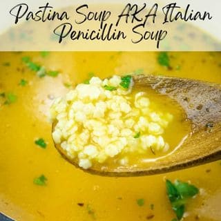 Close-up of a wooden spoon in pastina soup with herbs, labeled "Pastina Soup AKA Italian Penicillin Soup.